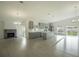 Spacious open-concept living area with modern gray kitchen, tile fireplace, and abundant natural light at 705 Wood Ln, Kissimmee, FL 34759