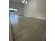 Bright and airy living room with wood flooring and sliding glass doors at 705 Wood Ln, Kissimmee, FL 34759
