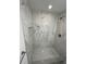 A tiled shower with a built-in niche and a shower head at 705 Wood Ln, Kissimmee, FL 34759