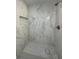Shower featuring marble tile, built-in niche, and bench at 705 Wood Ln, Kissimmee, FL 34759