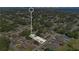 Aerial view showing home's location in a residential neighborhood with mature trees and nearby lake at 710 California Ave, St Cloud, FL 34769