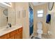 Modest bathroom with a wood vanity and a blue shower curtain at 710 California Ave, St Cloud, FL 34769