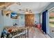 Bedroom with wood-look floors, blue walls, hunting decor, a ceiling fan, and barn doors at 710 California Ave, St Cloud, FL 34769