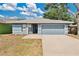 Charming single-story home featuring a well-maintained lawn, neutral paint, and an attached two-car garage at 710 California Ave, St Cloud, FL 34769