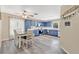 Bright kitchen with blue cabinets, stainless steel appliances, a window with natural light, and a dining table at 710 California Ave, St Cloud, FL 34769