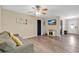 Bright living room featuring modern flooring, neutral paint, and a comfortable couch with yellow throw pillows at 710 California Ave, St Cloud, FL 34769