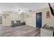 Living room featuring modern floors, neutral paint, a comfortable couch, and an entertainment center with a TV at 710 California Ave, St Cloud, FL 34769