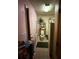 Modest bathroom with a small area rug, open shelf storage, and a toilet with plants at 716 Grove Ave, Orlando, FL 32805