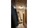 Modest bathroom with tiled floor and shelving unit with toilet paper and an air freshener at 716 Grove Ave, Orlando, FL 32805