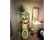 Small bathroom with open shelving and a plant on top of the toilet at 716 Grove Ave, Orlando, FL 32805