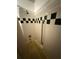 White tiled shower with decorative dark green squares and handrails for accessible bathing at 716 Grove Ave, Orlando, FL 32805