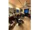 Salon interior with multiple salon chairs, a sofa, shelving units, and lots of products at 716 Grove Ave, Orlando, FL 32805