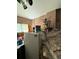 A cluttered storage area with a mini refrigerator, storage bins, and a window at 716 Grove Ave, Orlando, FL 32805