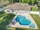 Aerial view of a home highlighting a backyard pool, patio furniture, and a fenced-in yard at 7823 Bell Blvd, Orlando, FL 32810