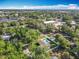 Aerial view showing the neighborhood, trees, and a backyard pool at 7823 Bell Blvd, Orlando, FL 32810