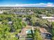 Aerial view of a fenced-in backyard featuring a pool, spa, well-kept lawn, and a neighboring community at 7823 Bell Blvd, Orlando, FL 32810