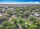 An aerial view of a property surrounded by lush trees and greenery in a peaceful neighborhood at 7823 Bell Blvd, Orlando, FL 32810