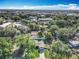 An aerial view of a home with mature trees and an inviting driveway in a beautiful neighborhood setting at 7823 Bell Blvd, Orlando, FL 32810