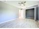 Clean bedroom showcases tile floors, neutral gray walls, ceiling fan and a closet at 7823 Bell Blvd, Orlando, FL 32810
