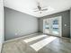 A spacious bedroom featuring tile floors, ceiling fan and double doors leading to outside at 7823 Bell Blvd, Orlando, FL 32810