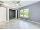 Bedroom with large window, ceiling fan, and closet with open doors with tiled floors at 7823 Bell Blvd, Orlando, FL 32810