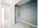 A closet space with a metal rack, gray walls, and light-colored tile flooring for optimal storage and style at 7823 Bell Blvd, Orlando, FL 32810