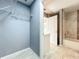 Hallway view to a bathroom with modern, marble-look tile, wire racks, and good lighting at 7823 Bell Blvd, Orlando, FL 32810