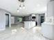 Open-concept kitchen with white cabinets, an island, and modern lighting at 7823 Bell Blvd, Orlando, FL 32810