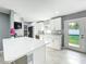 Modern kitchen featuring sleek white cabinets, new stainless appliances, and a spacious island at 7823 Bell Blvd, Orlando, FL 32810