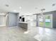Modern kitchen with white cabinets, a breakfast bar, and stainless steel appliances at 7823 Bell Blvd, Orlando, FL 32810