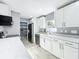 Modern kitchen features white cabinets, stainless steel appliances, and marble countertops at 7823 Bell Blvd, Orlando, FL 32810