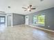 Bright living room showcasing sleek tile floors and a modern ceiling fan at 7823 Bell Blvd, Orlando, FL 32810
