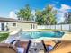 Inviting backyard showcasing a refreshing pool and spa, complete with lounge chairs for relaxation in the sun at 7823 Bell Blvd, Orlando, FL 32810