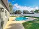 Backyard showcasing a private pool, and a spacious patio area surrounded by a white fence, creating an outdoor retreat at 7823 Bell Blvd, Orlando, FL 32810