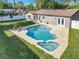 Aerial view of a private backyard oasis with a sparkling pool, spa, and ample patio space for outdoor entertaining at 7823 Bell Blvd, Orlando, FL 32810