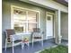 Cozy front porch with chairs, creating an inviting and relaxing outdoor seating area at 7823 Bell Blvd, Orlando, FL 32810