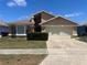 Charming single Gathering home featuring a two-car garage and manicured front lawn at 849 Long Bay Ct, Kissimmee, FL 34741