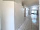 Neutral hallway with ceramic tile flooring that leads to a bright living space at 849 Long Bay Ct, Kissimmee, FL 34741