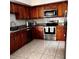 Updated kitchen boasts stainless appliances, sleek counters and tile flooring at 849 Long Bay Ct, Kissimmee, FL 34741