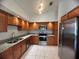 Updated kitchen with stainless steel appliances, granite counters, and wood cabinetry at 849 Long Bay Ct, Kissimmee, FL 34741