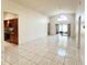 Bright, open-concept living area with tile flooring and access to the kitchen and lanai at 849 Long Bay Ct, Kissimmee, FL 34741