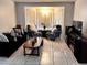 Relaxing living room featuring bay windows, armchairs and dark sofa at 849 Long Bay Ct, Kissimmee, FL 34741