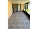 Enclosed patio with textured tile and view of backyard at 849 Long Bay Ct, Kissimmee, FL 34741