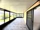 Enclosed sunroom featuring tile flooring, a screened wall, and a sliding glass door at 849 Long Bay Ct, Kissimmee, FL 34741