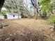 View of the backyard with shed shaded by mature trees, offers potential for a tranquil retreat at 906 San Domingo Rd, Orlando, FL 32808