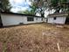 Spacious backyard with a shed and mature trees, providing privacy and room for outdoor activities at 906 San Domingo Rd, Orlando, FL 32808