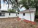 A view of the backyard featuring a shed and mature trees, offering a serene outdoor space at 906 San Domingo Rd, Orlando, FL 32808