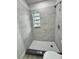 Bathroom shower features updated tile, fixtures, and a small window, offering a modern aesthetic at 906 San Domingo Rd, Orlando, FL 32808