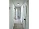 Hallway with gray wood-look floors and white painted doors leading to rooms in the house at 906 San Domingo Rd, Orlando, FL 32808
