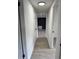 Bright hallway featuring light wood floors and neutral paint, leading to a room with black accent wall at 906 San Domingo Rd, Orlando, FL 32808